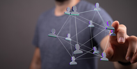 A person's finger interacts with a network of connections, visualizing digital concepts like communication and teamwork. Focus on collaboration.