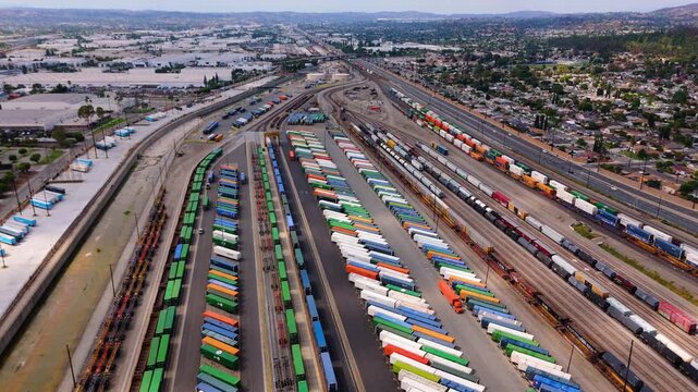 Aerial tilt-down view of cargo trains and containers at logistics terminal in October 7, 2025