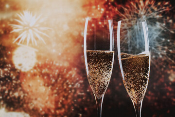 toasting with champagne glasses against holiday lights