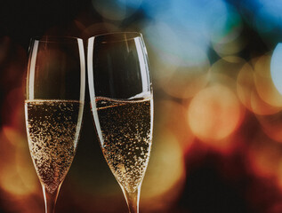 toasting with champagne glasses against holiday lights