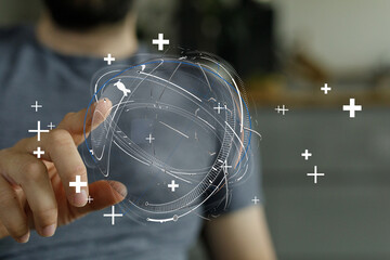 A person interacting with a holographic globe projection, symbolizing global connection, innovation, and technological advancements.