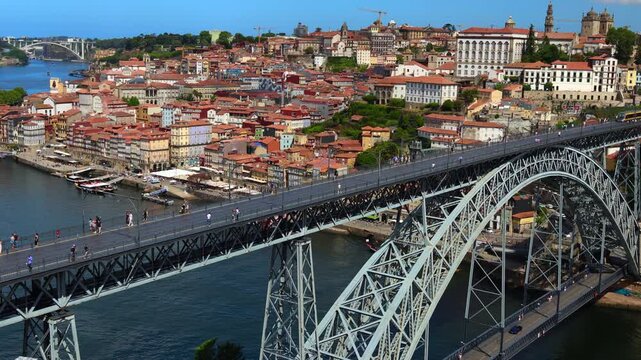 Metro crosses famous bridge Ponte Lu&iacute;s I in Porto, Portugal. Aerial view. 4K.