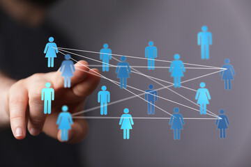 Concept image of a hand reaching out to a network, symbolizing connection, teamwork, and digital...