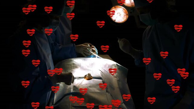 Tray opening surgeon arranging and assistant adjusting lamp, hearts floating showing teamwork