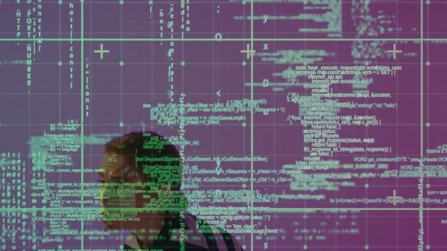 Adult woman raising hands, inspecting floating green code grid flickering into view in tech studio