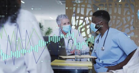 Senior doctor opening laptop in hospital meeting, showing animated graphs guiding review - Powered by Adobe