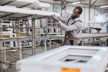 Factory worker preparing pvc window frames for shipment