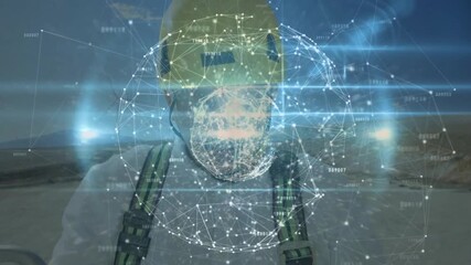 Mature engineer on wind farm site initiating network forming digital sphere around face for data - Powered by Adobe