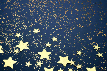 Abstract festive blue background with golden stars.