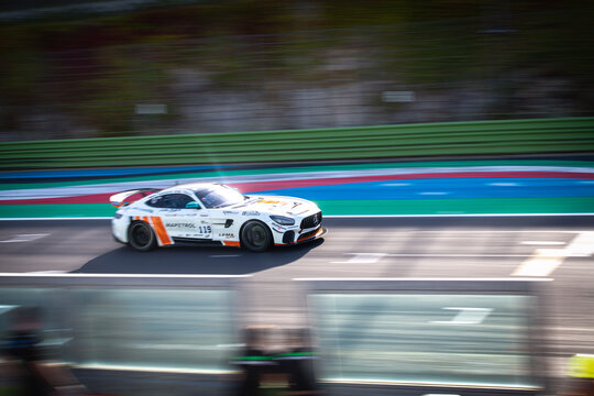 Mercedes AMG GT racing car on asphalt circuit main straight motion blur