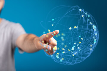 A close-up of a human hand interacting with a digital sphere, representing concepts of technology, connectivity, and network.