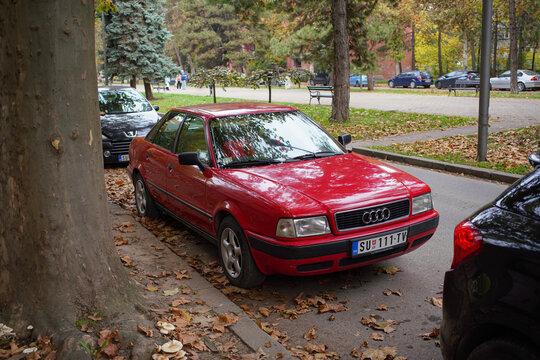 Iconic red Audi 80 B4 (related Audi 90, B3) sedan in excellent condition is parked on an autumn street, cult youngtimer from late 80s and early 90s. October 30, 2024 Subotica, Serbia