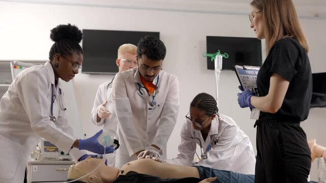 Medical students practicing CPR on a training dummy under supervision