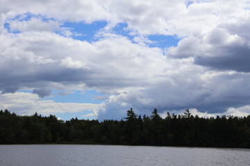 A beautiful cloud formation over a lake in the Adirondacks on a sunny day.