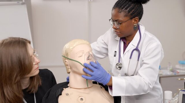 Medical students practicing intubation procedure on a training dummy