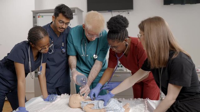 Diverse medical students learning infant CPR on a resuscitation dummy