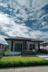 A contemporary home featuring a beautifully landscaped garden sits beneath a cloudy sky, surrounded by a peaceful suburban neighborhood, all illuminated by the soft glow of the afternoon sun