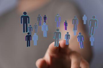 Abstract image of a hand interacting with digital human figures representing social connections,...