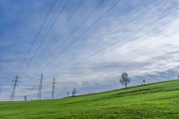 Power lines on a grassy ridge