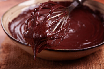 a bowl of chocolate dough, a whisk for whipping, baking, structure and consistency, homemade, top view, no people,