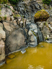 Stone wall on river bank in nature