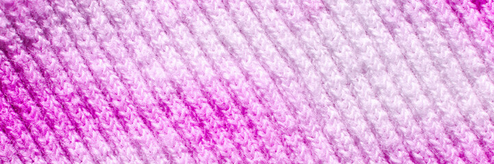 Close-up of vibrant pink and white knit wool texture showing detailed pattern and soft material.