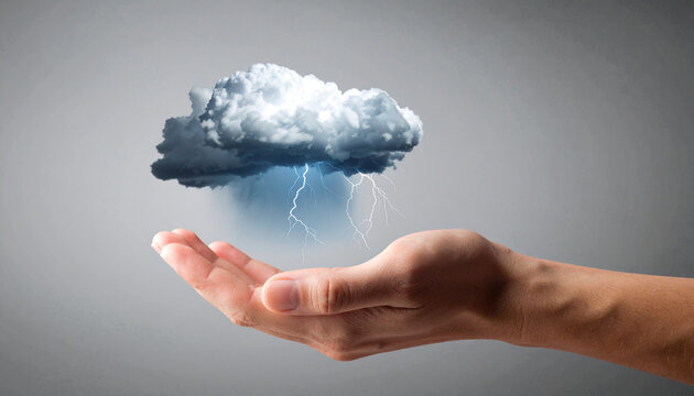 Hand holding a storm cloud with lightning