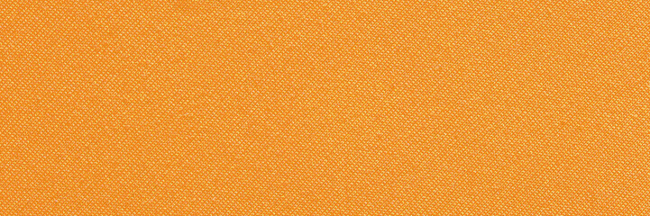 Close-up of orange textile fabric texture with fine woven pattern for background design.