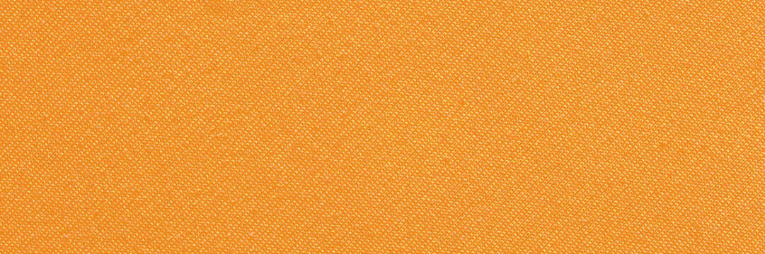 Close-up of orange textile fabric texture with fine woven pattern for background design.