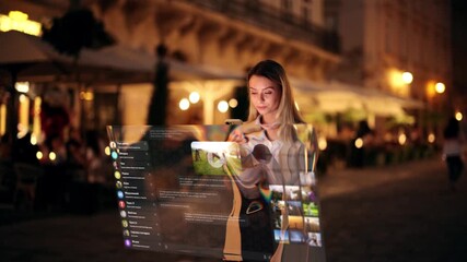 Young woman chatting through a glowing holographic interface on the street at night, concept of augmented reality communication and futuristic technology - Powered by Adobe