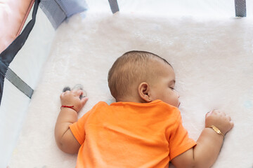 Baby infant sleeping peacefully in crib during nap