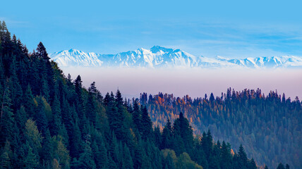 Snow-covered peak surrounded by autumn scenery