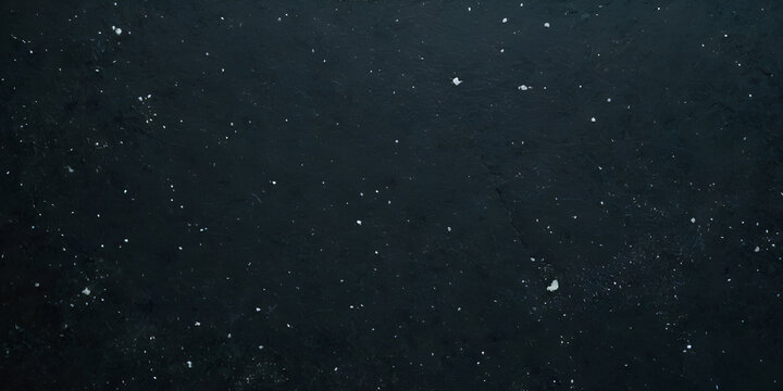 Deep space dark textured background with numerous small white flecks