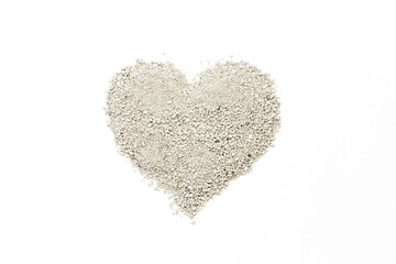 Heart shape created from fine small granules of cat litter on a white background, symbolizing love and nature, showcasing texture and simplicity in a minimalist design concept