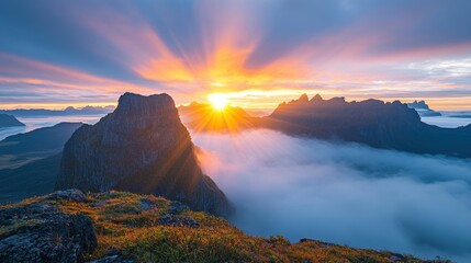 Naklejka premium Stunning sunrise over misty mountains with vibrant colors in the sky