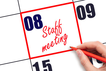 8 th day of the month.  Hand writing Staff meeting reminder and drawing red frame on calendar with...