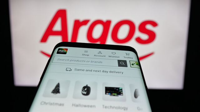 Stuttgart, Germany - 10-15-2025: Mobile phone with website of British retail company Argos Limited on screen in front of logo. Focus on top-left of phone display.