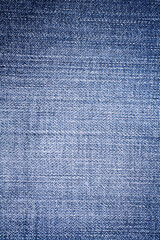 Light blue denim fabric with seam stitching, detailed jeans textile texture for fashion and design backgrounds.