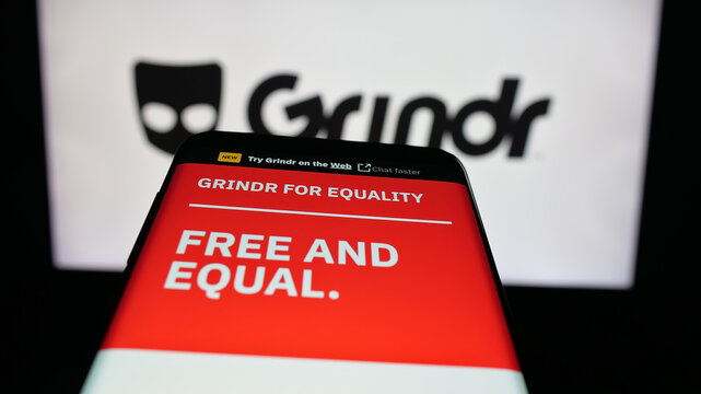 Stuttgart, Germany - 10-15-2025: Mobile phone with website of LGBT social media platform company Grindr Inc on screen in front of logo. Focus on top-left of phone display.