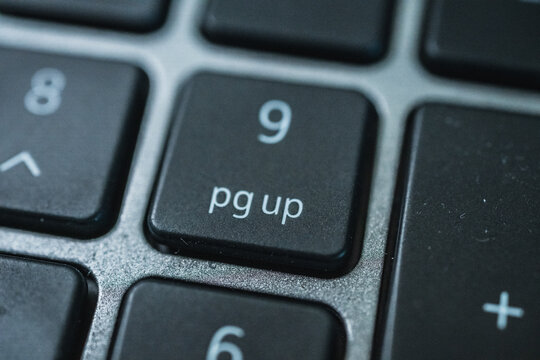 Macro detail of numeric keypad pg up key on metallic keyboard design.