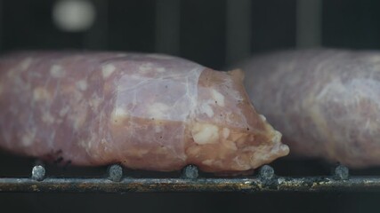 Raw Sausage Links Beginning to Cook on a Smoker Grill Grate