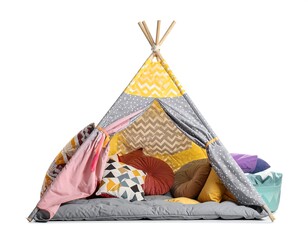 A colorful play tent with pillows inside, on a padded mat, and a basket of other pillows