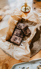 A brownie is sitting in a brown paper bag on a table