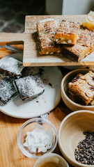A table with a variety of desserts, including brownies and cookies
