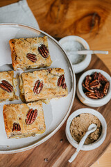 A plate of four peanut butter and jelly sandwiches sits on a wooden table