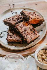 A plate of brownies with chocolate chips on top