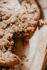 A cookie is cut in half and is sitting on a piece of paper