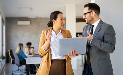 Fototapeta na wymiar Portrait of successful business people working, talking together in corporate office during work.