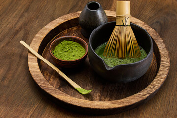 Traditional Matcha Preparation. High-angle view of matcha tea being prepared with a bamboo whisk