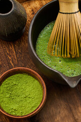 Traditional Matcha Preparation. High-angle view of matcha tea being prepared with a bamboo whisk